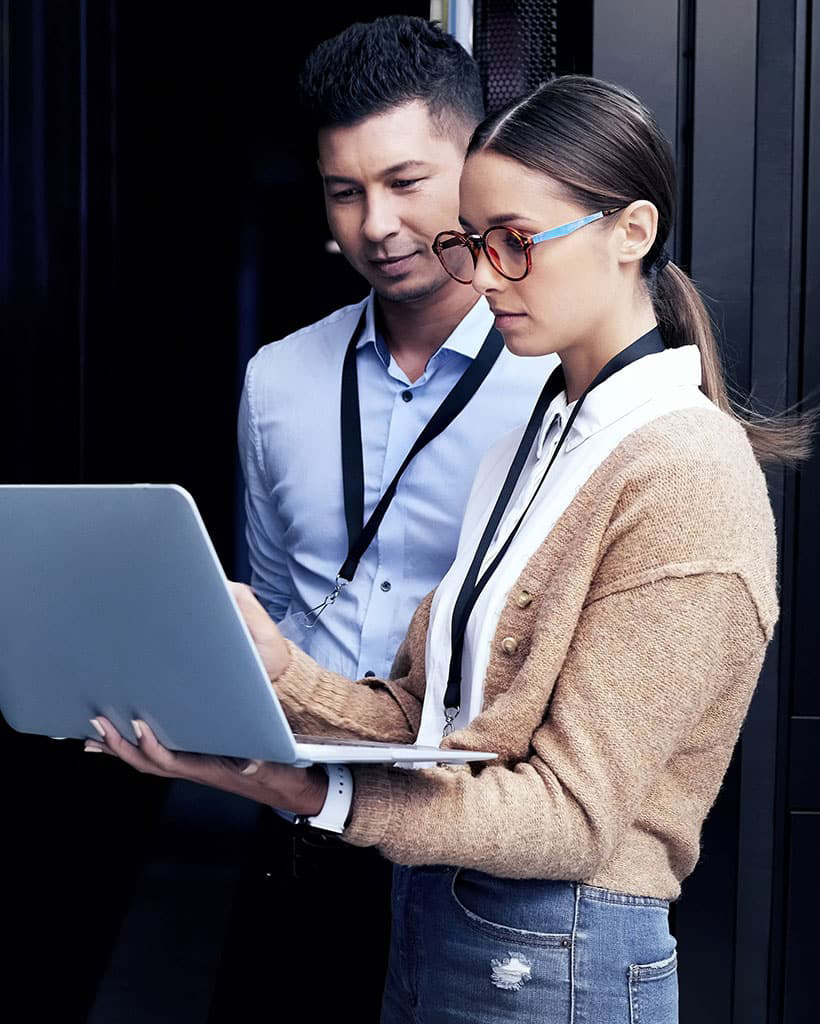 Two colleagues looking at a laptop