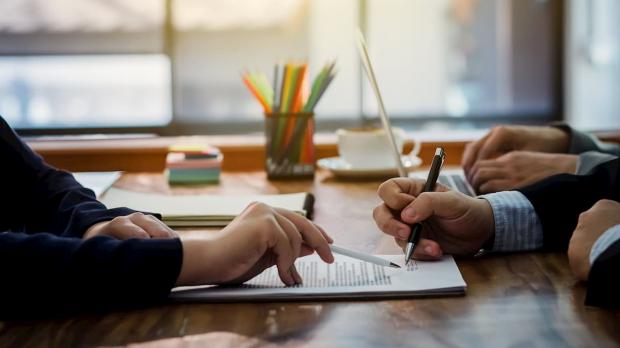 Two businessmen signing a contract